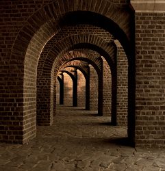 Series of brick arches forming a repeating corridor