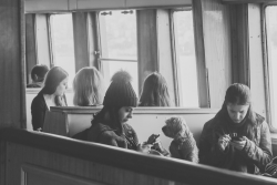 People sitting together but focused on their phones, illustrating distraction and reduced emotional connection