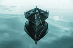 Still boat reflected on calm water, symbolising stability and lack of movement in a relationship
