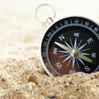 “Compass on sand representing direction and structure in constructive communication